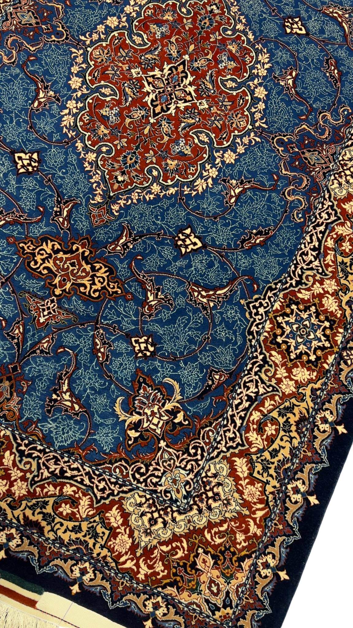Handmade wool and silk Persian rug showcasing traditional medallion design.